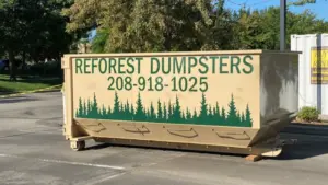Reforest Dumpsters container in a paved commercial lot with a storage container and trees in the background