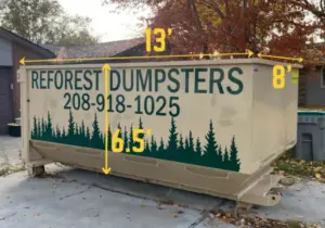 Reforest Dumpsters container with labeled dimensions -- 13 feet long, 8 feet wide, 5 feet tall -- on a gravel lot